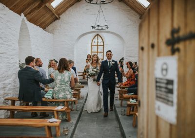 Couple walking down the aisle in an ancient chapel