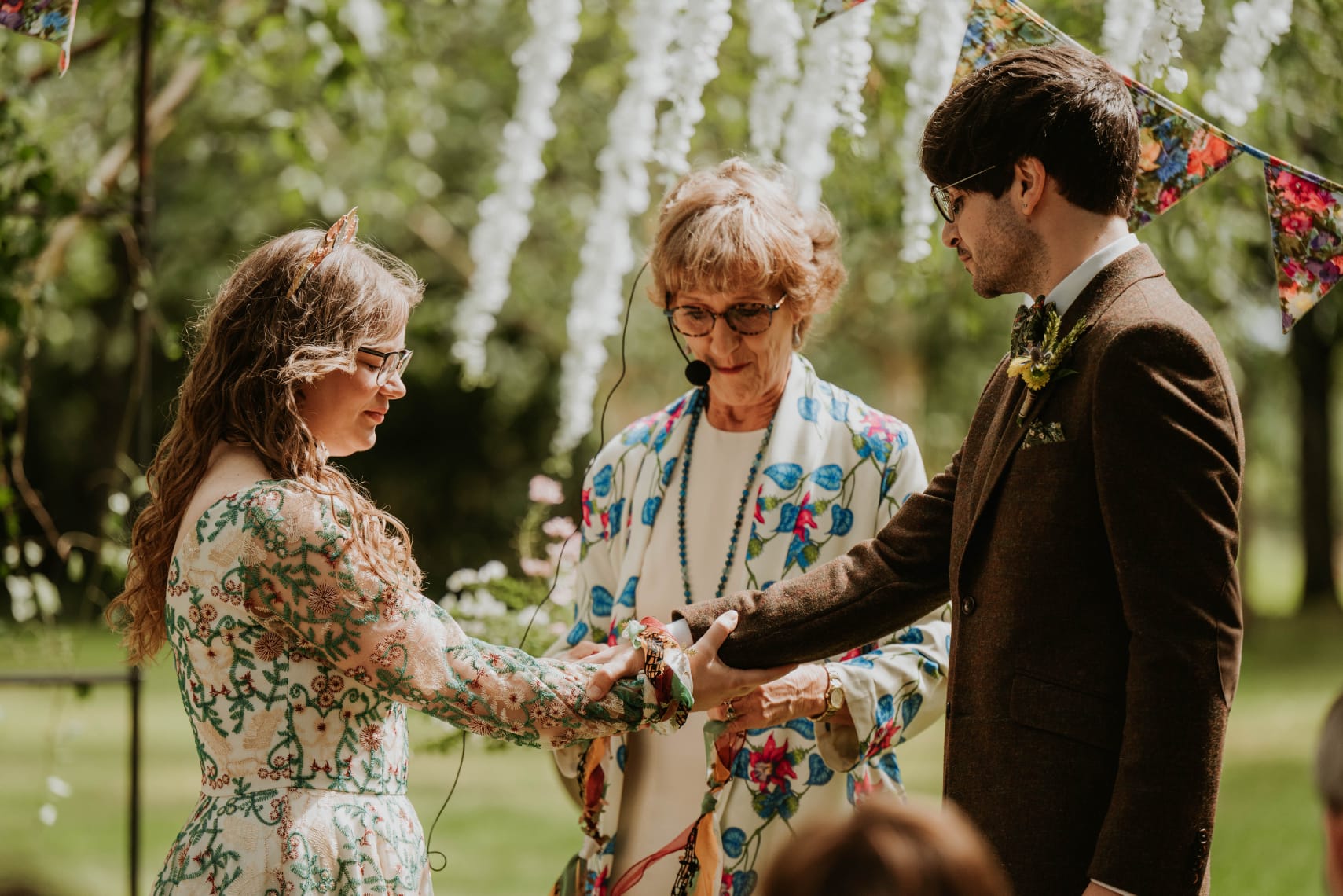 Handfasting ritual in a colourful summer celebrant wedding